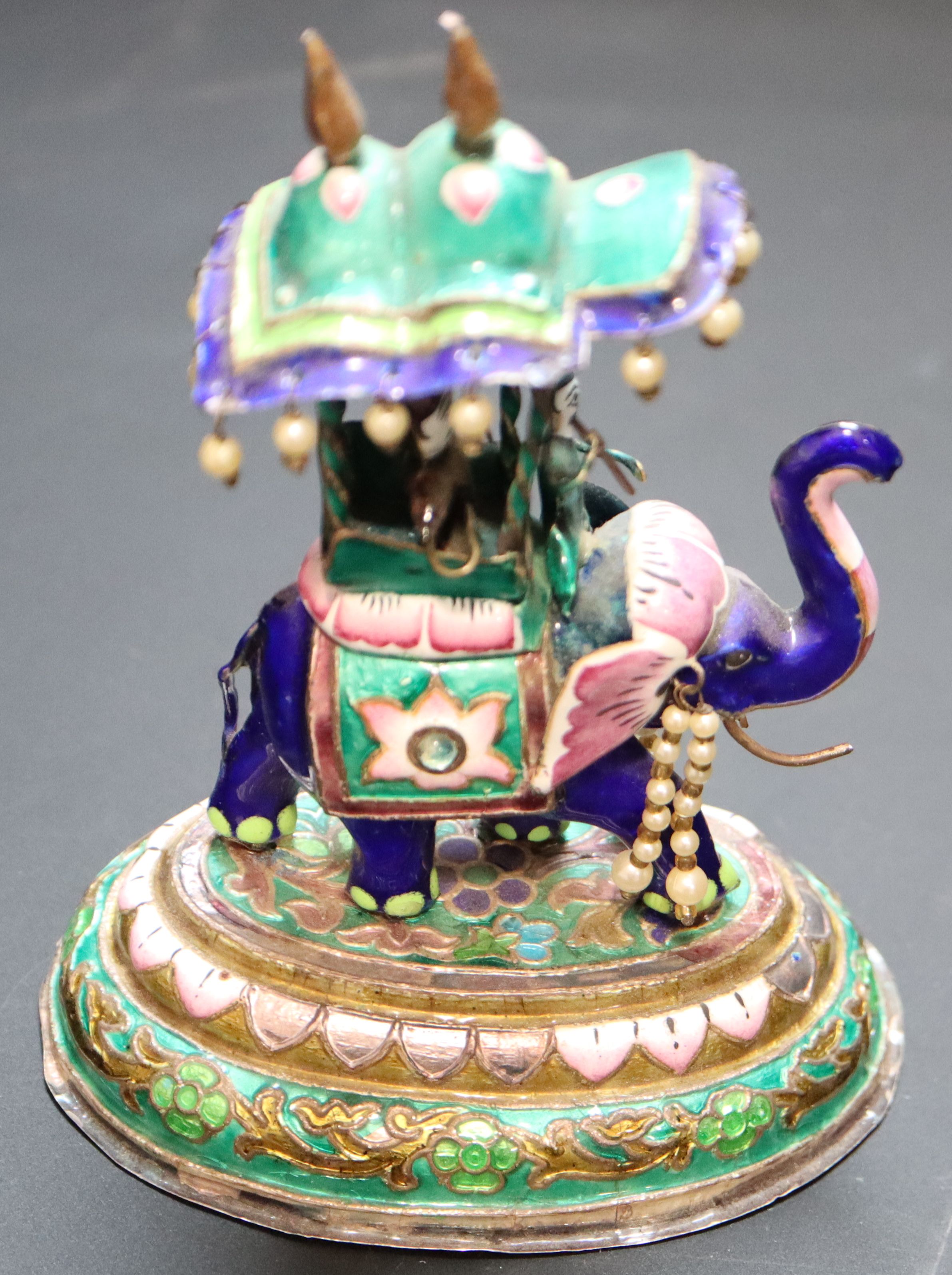 An Indian enamelled white metal miniature elephant with howdah, height 13.7cm, gross 295 grams.